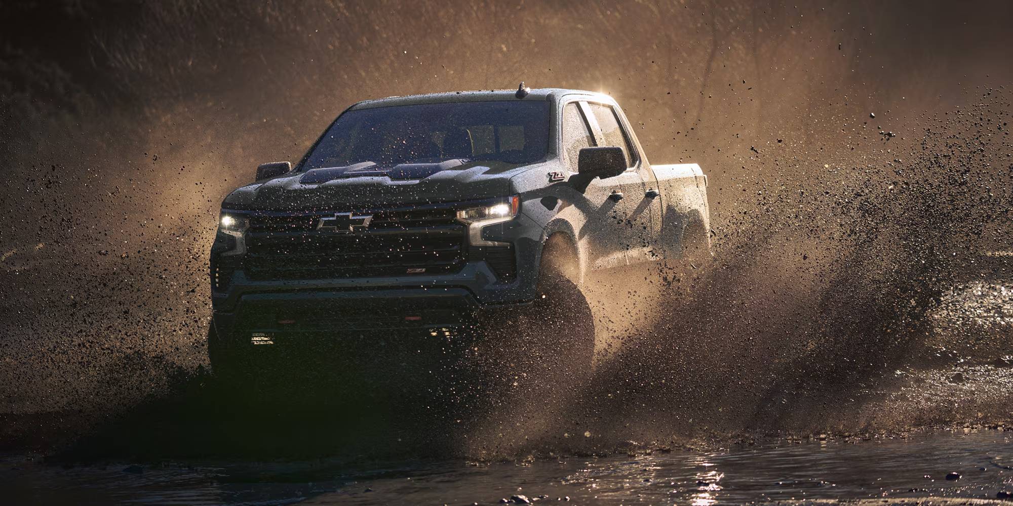Chevy Silverado driving through mud